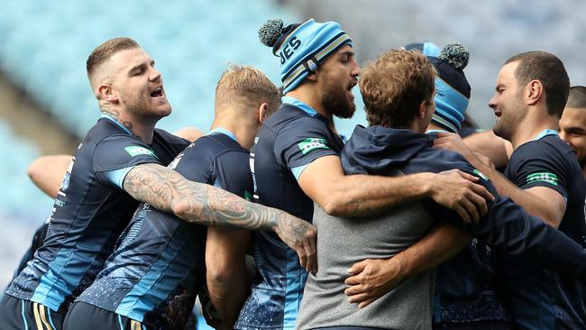 The Blues players laugh as they form a huddle during their captain’s run.