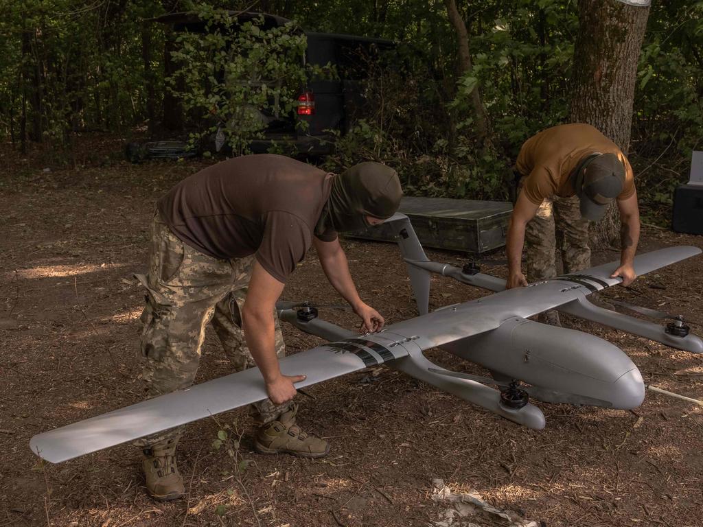 Ukrainian military drone operators of the 22nd Mechanized Brigade assemble a Poseidon reconnaissance unmanned aerial vehicle on their position, near the border with Russia. Picture: AFP