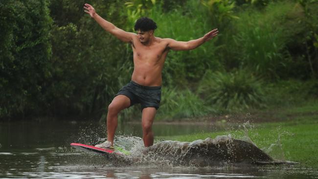 Paeroa Paul has fun in the floodwaters at Flooded Gum Park at Pacific Pines. Picture: Glenn Hampson