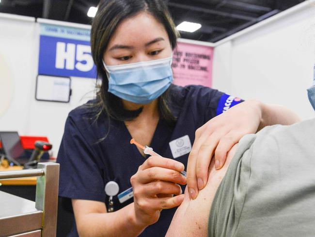 ADELAIDE, AUSTRALIA - NewsWire Photos NOVEMBER 4, 2021: SA Health vaccinator Xuan gives paramedic Sharon Hennessy a Covid booster vaccine at Wayville Vaccination Clinic. Picture: NCA NewsWire/Brenton Edwards