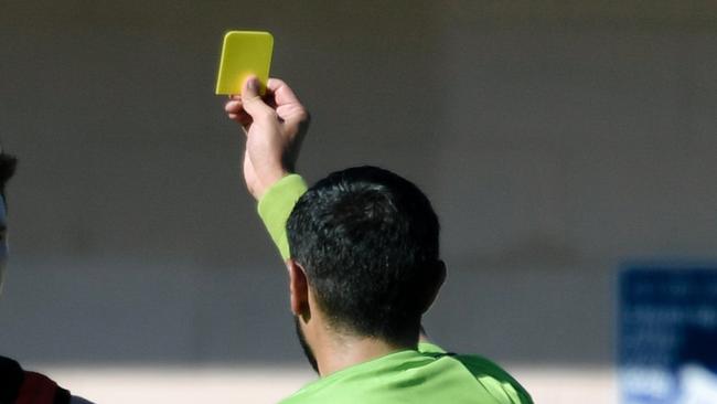 Ryan Spittle reacts while getting yellow-carded by an umpire during the Goodwood Saints versus Tea Tree Gully game in Adelaide, Saturday, April 21, 2018.  (AAP Image/Morgan Sette)