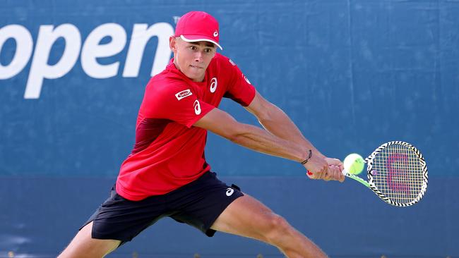 Austalia’s Alex de Minaur returns a shot against Pierre-Hugues Herbert of France