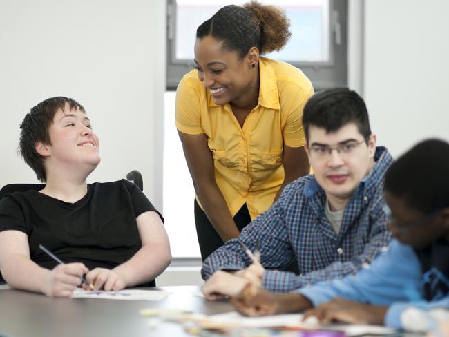 Diverse group of students with disabilities doing arts and crafts.