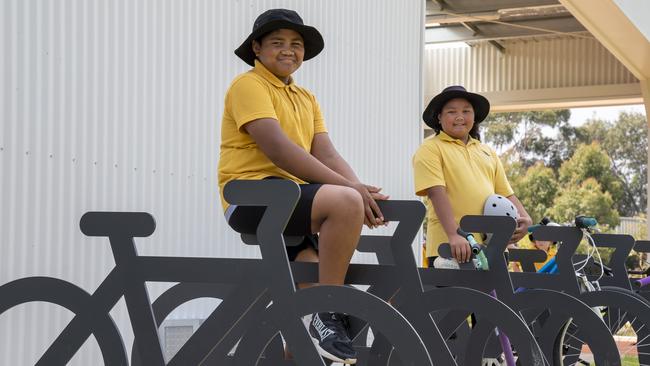 Students Joe and Carolyn at bike racks in their rebuilt Olympic Village Primary School in Heidelberg West. Picture: Andy Brownbill