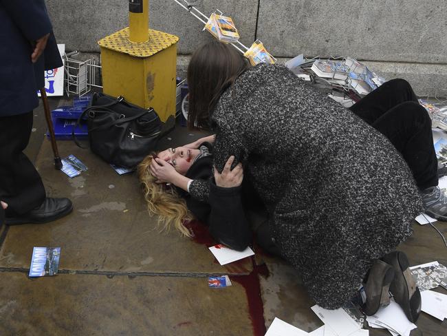 This woman was knocked into a postcard stand. Picture: Reuters