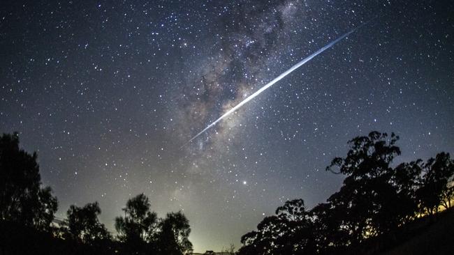 About 40 of Elon Musk's Starlink satellites streak through the night sky. The satellites appear as a streak due to the speed of their movement and the 30 second exposure of the shot. Picture: Rodd Westwood