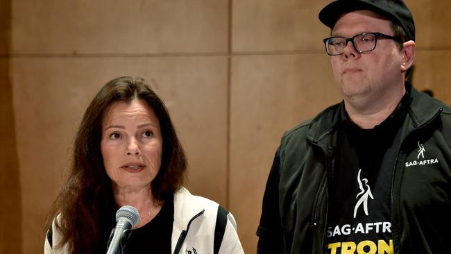 National Executive Director and Chief Negotiator Duncan Crabtree-Ireland looks on as SAG-AFTRA President Fran Drescher (L) speaks to reporters. Picture: AFP.