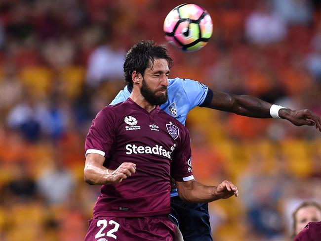 Thomas Broich of the Brisbane Roar (left) heads a ball away from Bernie Ibini-Isei of Sydney FC during their round 7 A-League game at Suncorp Stadium in Brisbane, Saturday, Nov. 19, 2016. (AAP Image/Dan Peled) NO ARCHIVING, EDITORIAL USE ONLY