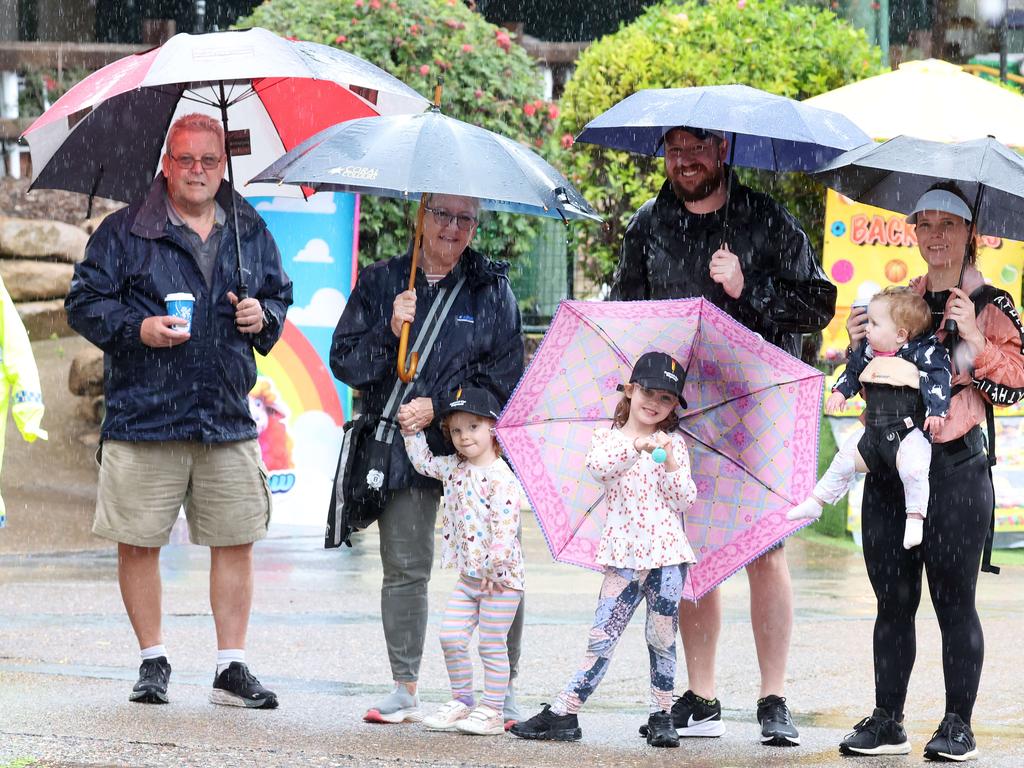 McMahon family in the rain, Kip, Michelle, Scott, Marion and kids Ella, 5, Chloe, 3, Maxine, 1, at People‘s Day at the Ekka. Picture: Liam Kidston