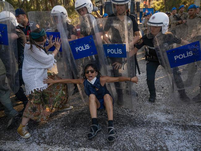 A protester resists Turkish police during clashes as local residents and environmental activists demonstrate against a deforestation project. Picture: Bulent Kilic/AFP