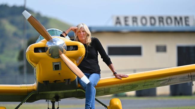 Jennifer Beck, 72, former senior flying instructor and current liaison officer for the Gympie airport, with her yellow Thatcher CX4 ultralight plane. Picture: Lyndon Mechielsen