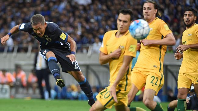 Japan's midfielder Yosuke Ideguchi (L) scores his screamer.