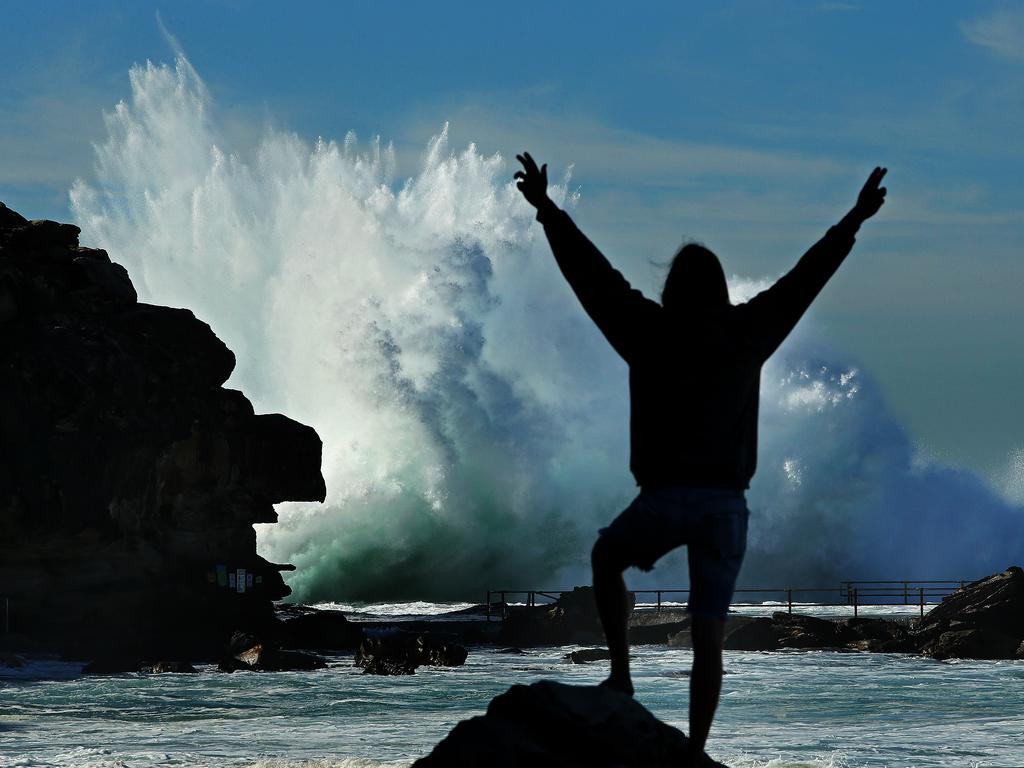 Brad Crane checks out huge waves pounding the rock pool at Nth Curl Curl on Sydney's Northern Beaches. Picture: Troy Snook