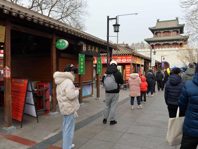 Residents queue to get a swab sample for Covid-19 coronavirus in Tianjin, in northern China. Picture: AFP