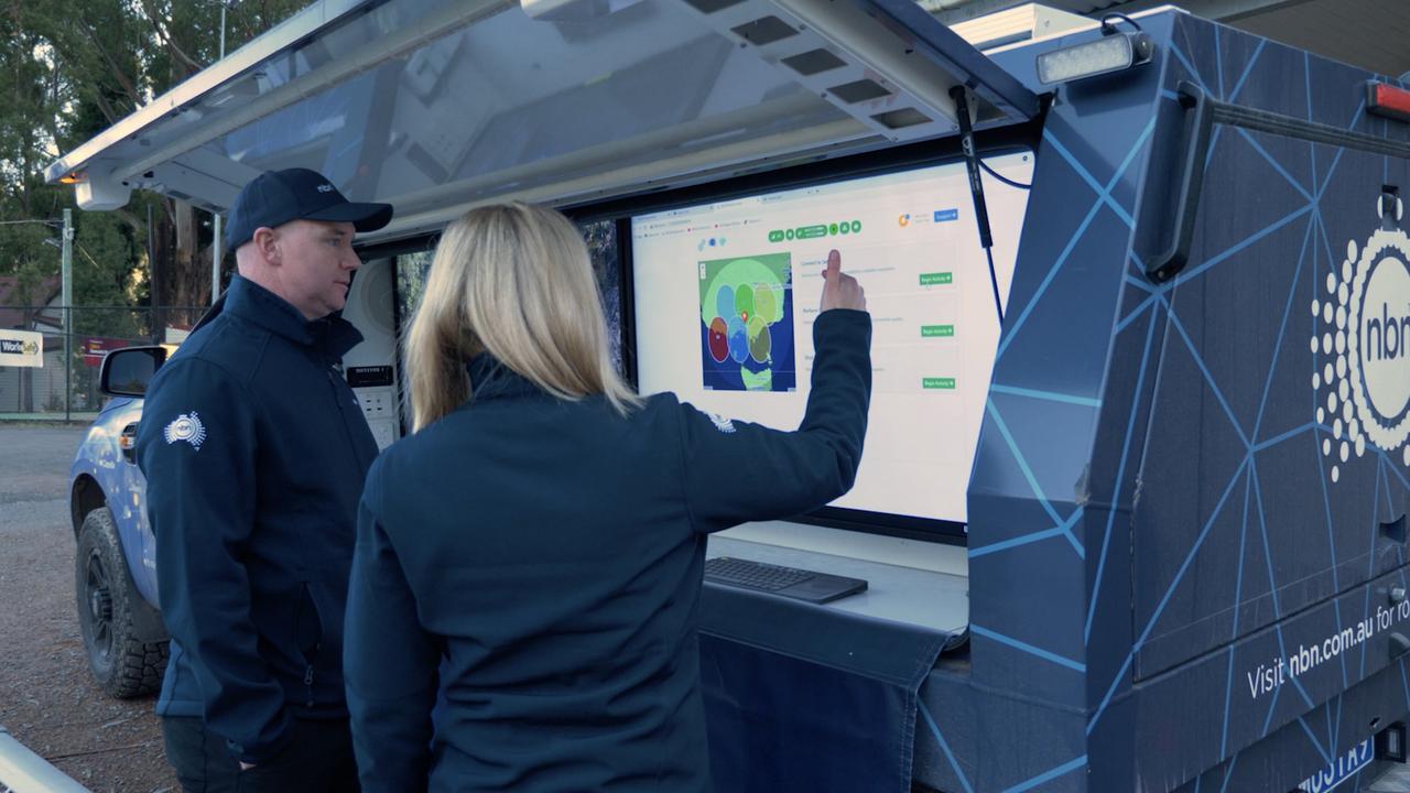 NBN local community engagement specialist Tim Burnham demonstrates the setup of an NBN Muster Truck following Victorian storms.