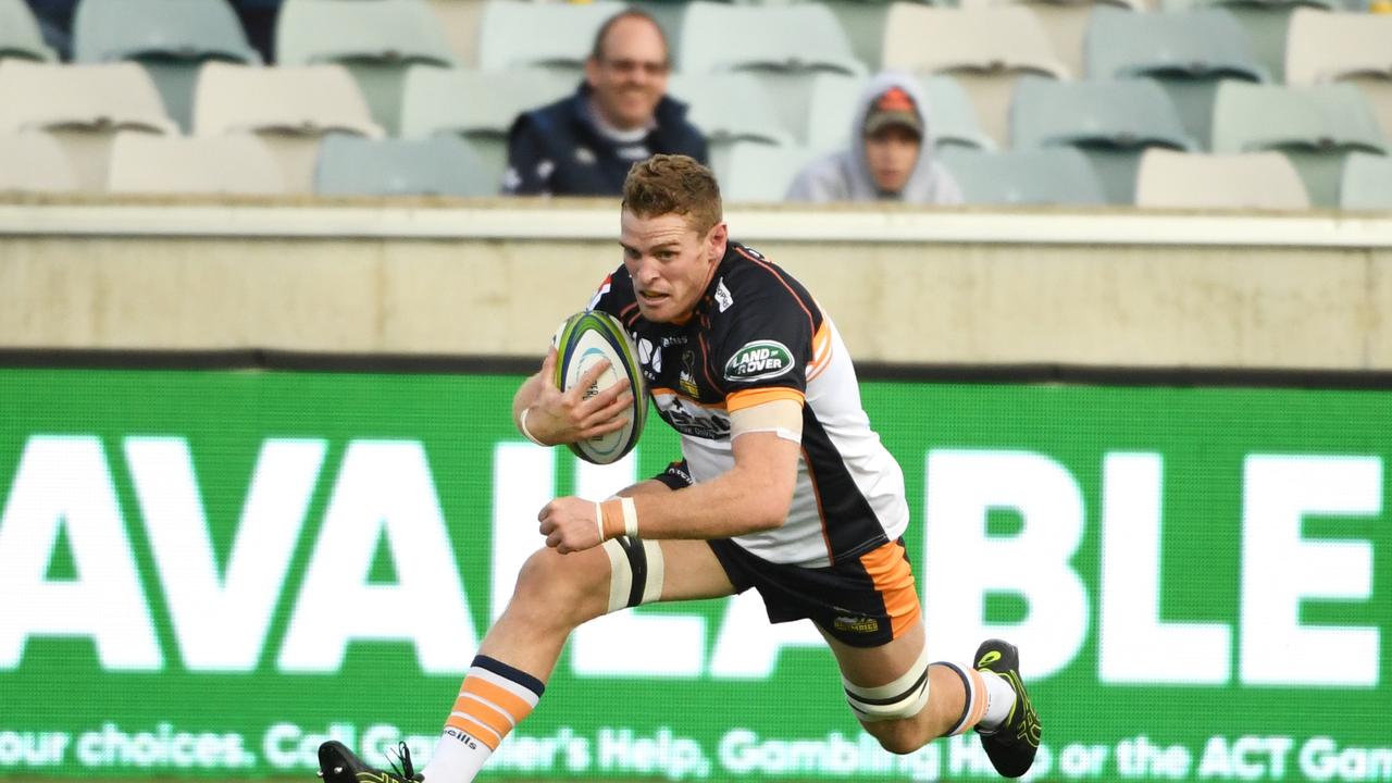 Tom Cusack of the Brumbies scores a try in front of a small crowd at GIO Stadium.