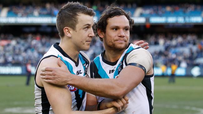 Trengove celebrates his first win with the Power with teammate Steven Motlop. Picture: Adam Trafford/AFL Media/Getty Images