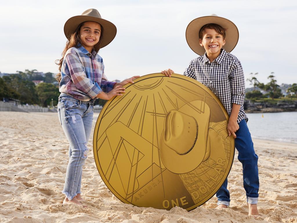 Mila and Hugo, both seven, in their Akubras with a giant version of the coin. Picture: Australia Post/David Swift.