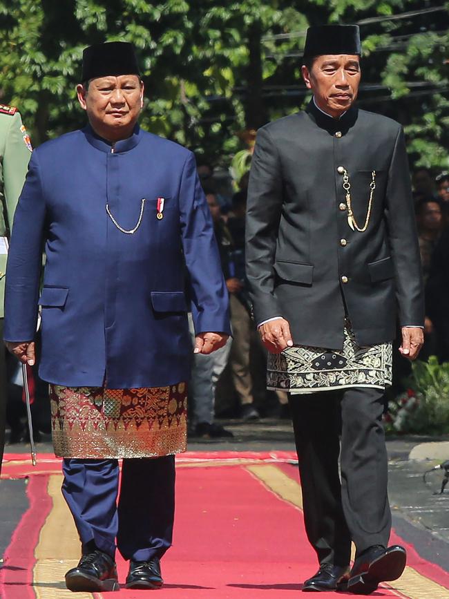 Indonesia’s President Prabowo Subianto, left, and his predecessor Joko Widodo review the troops during the presidential inauguration ceremony at the Presidential Palace in Jakarta on October 20, 2024. Picture: AFP