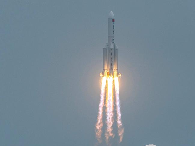 (FILES) In this file photo taken on April 29, 2021, a Long March 5B rocket, carrying China's Tianhe space station core module, lifts off from the Wenchang Space Launch Center in southern China's Hainan province. - China said on May 7, 2021 the risk of damage on Earth from a rocket which fell out of orbit after separating from Beijing's space station was "extremely low", after the United States warned it could crash down onto an inhabited area. (Photo by STR / AFP) / China OUT