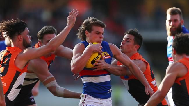 Western Bulldogs young gun Bailey Smith tries to burst through a Josh Kelly tackle. Picture: Mark Metcalfe/Getty Images.