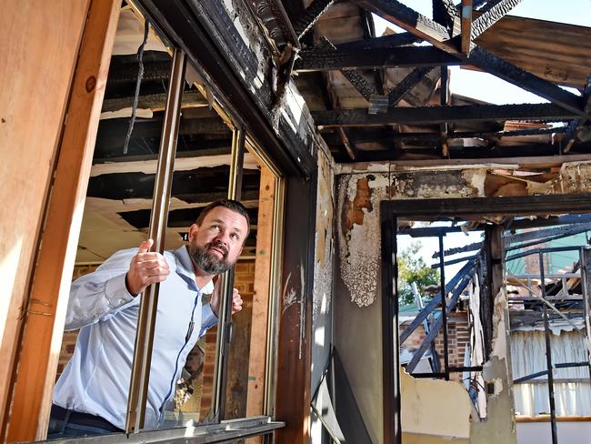 SUNDAY TELEGRAPH/AAP. First National Real Estate Agent Philip Martin poses during a photo shoot at his burnt-out property listing at Berkeley Vale on the Central Coast on Friday, May 14. The property was a drug lab that burnt down and is set to go to auction in June. AAP IMAGE / Troy Snook)