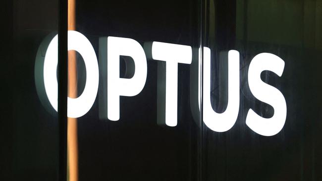 An illuminated sign is displayed in the window of an outlet for the Australian communications company Optus in Sydney on November 9, 2023. Australia's government on November 9 launched an investigation into a nationwide communications outage that crippled phone lines and severed internet access for 10 million customers countrywide. (Photo by DAVID GRAY / AFP)