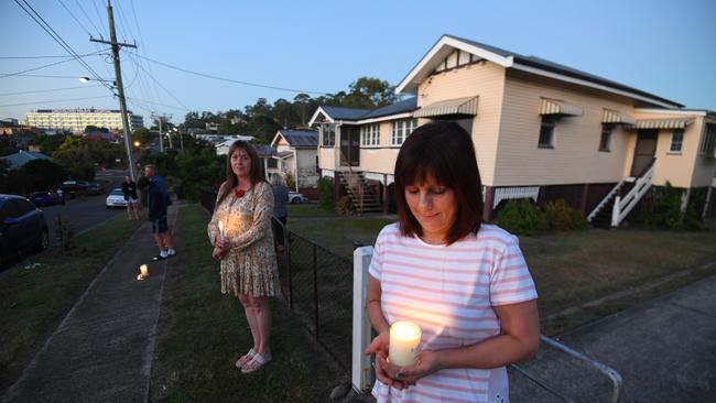 People stand outside their homes at dawn to commemorate Anzac Day in Brisbane, Saturday, April 25, 2019. Anzac Day is a national day of remembrance to commemorate the service and sacrifice of Australian and New Zealand service men and women. Due to COVID-19 restrictions marches and commemorative services have been banned for the first time in more than a century. (AAP Image/Dan Peled) NO ARCHIVING