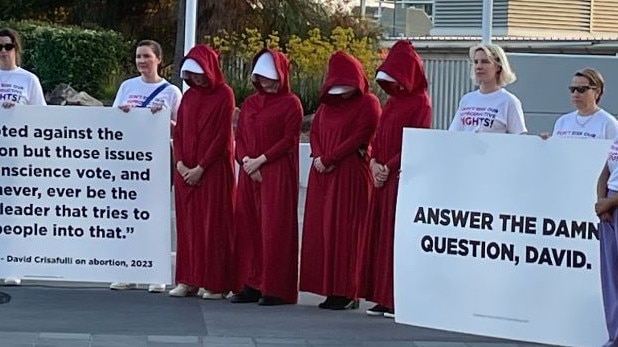 Protesters gather outside the venue for the Sky News/Courier-Mail People's Forum in Brisbane.