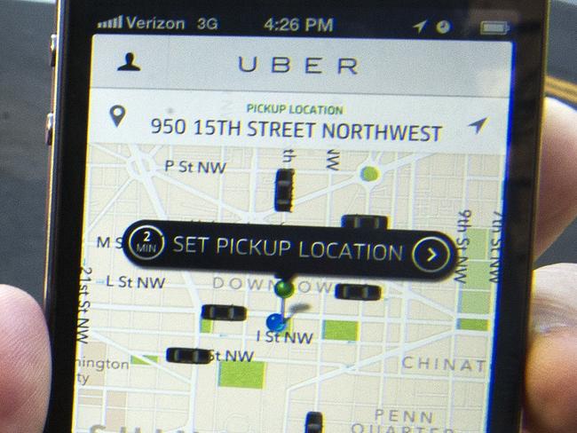 (FILES) The Uber App is shown in this February 14, 2013, file photo in Washington, DC. Uber teamed up with dining and travel smartphone applications on August 20, 2014, as the controversial Internet-age car-hailing service moved to park itself at the heart of mobile lifestyles. The San Francisco-based startup let about a dozen businesses such as Starbucks, Hyatt Hotels, United Airlines, TripAdvisor and restaurant reservation service OpenTable make it simple for people to summon Uber cars from inside their applications for smartphones or tablet computers. AFP Photo/Paul J. Richards/FILES