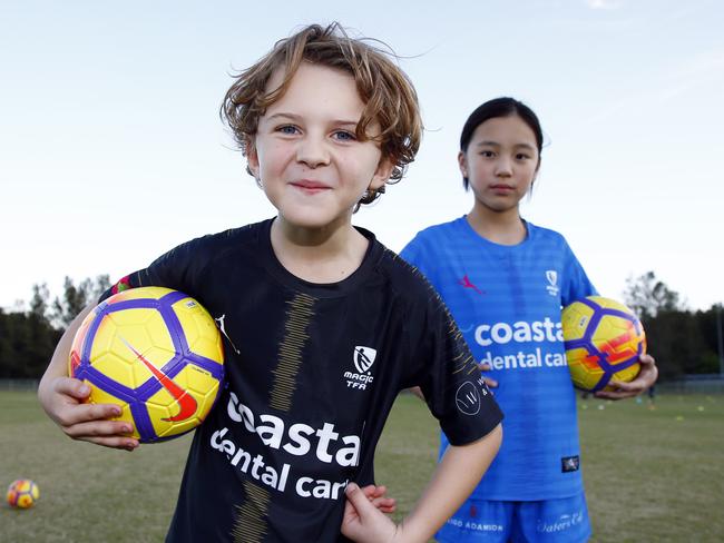 Eli May, 8, and Kayla Nguyen, 10, at soccer training in Carrara. Picture: Tertius Pickard