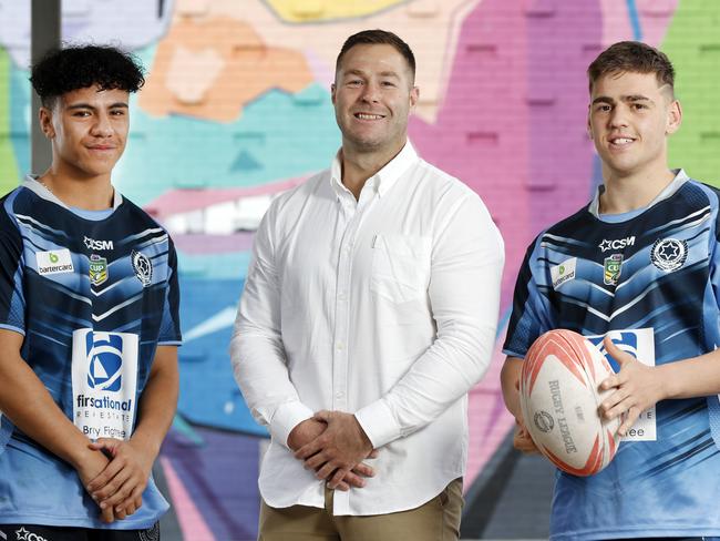 Trent Merrin with Schoolboy Cup players Viliami Mahe (left) and Dilan Asanoski at Illawarra SHS after the school unveiled a new field named after Trent Merrin who is a former student. Picture: Jonathan Ng