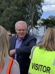 Prime Minister Scott Morrison giving MP Angie Bell a shoulder bump on his arrival at Neumann Steel in Currumbin. Photo: Emily Halloran