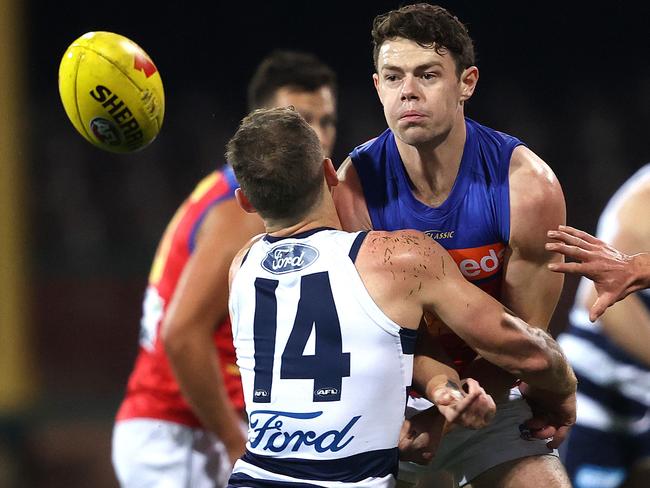 Brisbane's Lachie Neale handballs ahead of Geelong's Joel Selwood during the AFL match between the Geelong Cats and Brisbane Lions at the SCG on 9th July 2020, Sydney. Picture. Phil Hillyard