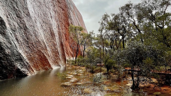A ranger in the Uluru-Kata Tjuta National Park captured 'rare and magical' images of waterfalls forming after a night of heavy rain. Picture: Facebook