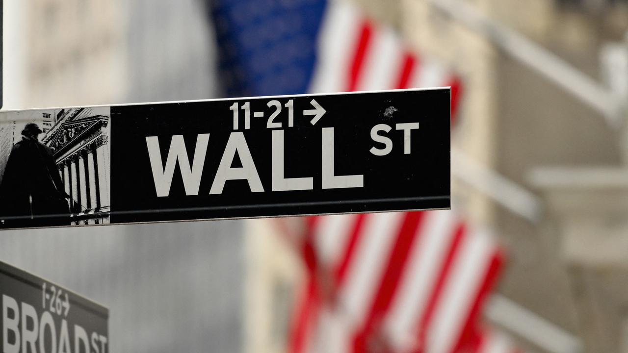 A street sign near the New York Stock Exchange at Wall Street. (Photo by ANGELA WEISS / AFP)