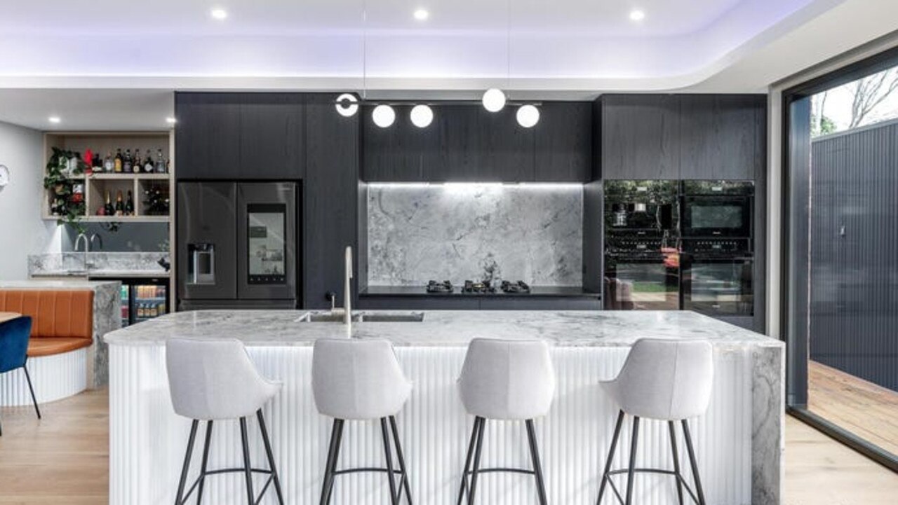 The kitchen is fitted with Miele appliances including a dishwasher, two wall ovens, an integrated combi-microwave and coffee machine, plus an integrated gas cooktop.