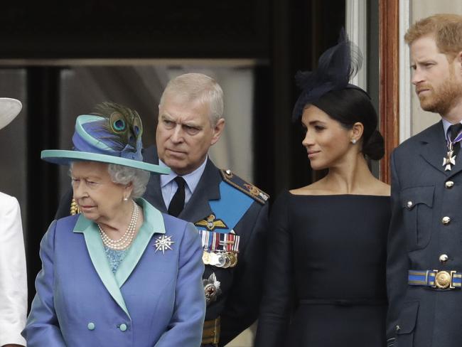 FILE - In this Tuesday, July 10, 2018 file photo Britain's Queen Elizabeth II, Prince Andrew, Meghan the Duchess of Sussex and Prince Harry stand on a balcony to watch a flypast of Royal Air Force aircraft pass over Buckingham Palace in London. As part of a surprise announcement distancing themselves from the British royal family, Prince Harry and his wife Meghan declared they will "work to become financially independent" _ a move that has not been clearly spelled out and could be fraught with obstacles. (AP Photo/Matt Dunham, File)