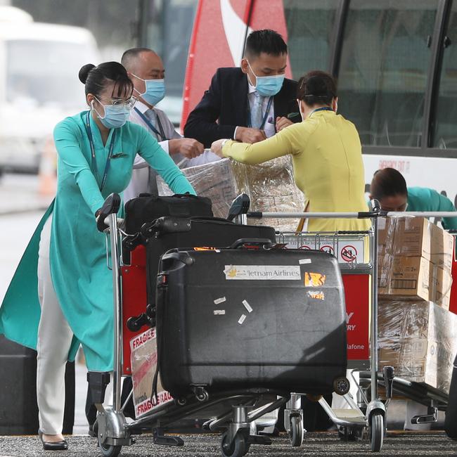 Flight crews take precautions at Sydney International Airport. Picture: John Grainger