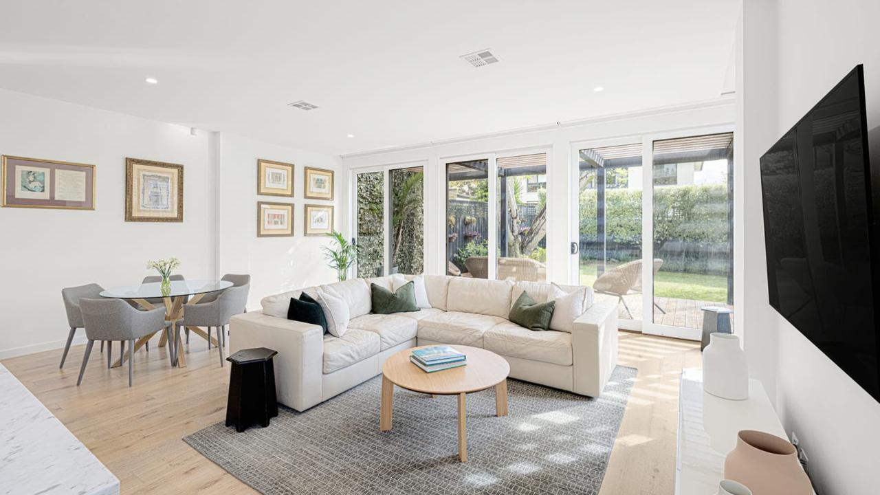 The light and bright dining and living area which opens out to the backyard.