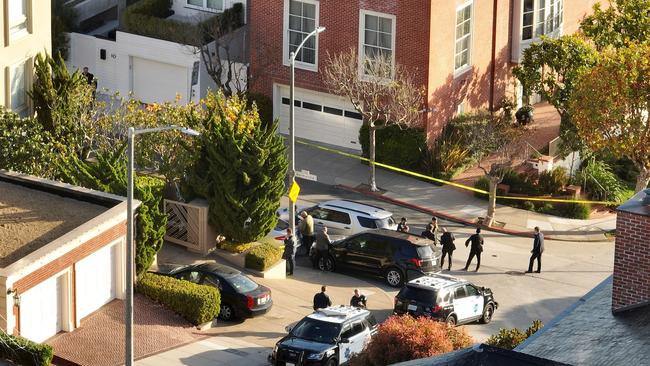 San Francisco police officers and FBI agents gather in front of the home of Nancy and Paul Pelosi on Saturday. Picture: AFP