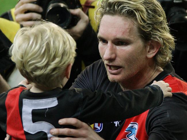 Essendon v Richmond at the MCG. James Hird gets his son Alexander after tonight's game.