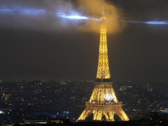 PARIS, FRANCE - JULY 26: A laser show is projected from the Eiffel Tower in Paris, France, during the opening ceremony of the 2024 Summer Olympics, Friday, July 26, 2024. (Photo by Brian Inganga - Pool/Getty Images)