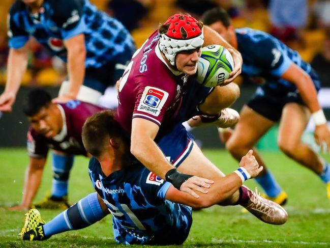 Reds' Fraser McReight is tackled by Ivan van Zyl during a match between Australia's Queensland Reds and South Africa's Bulls at Suncorp Stadium.