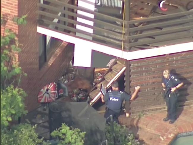 Police examine the collapsed balcony. Picture: Seven News.