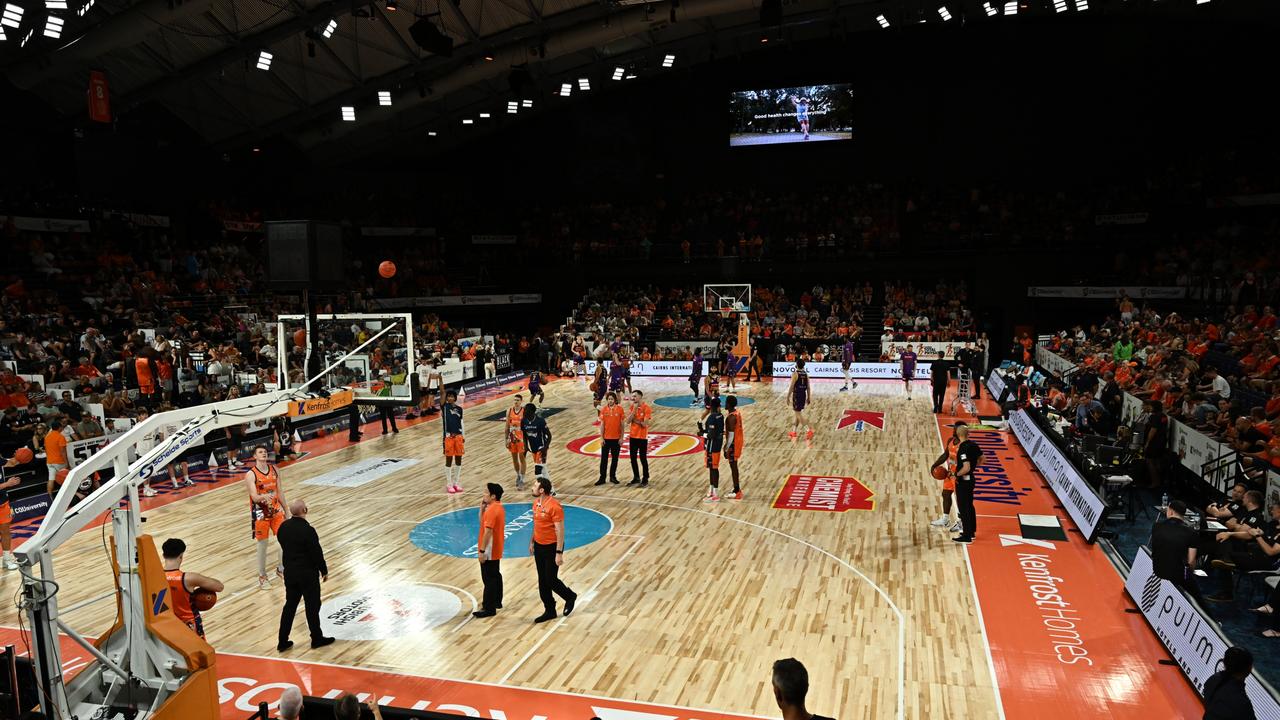 Players and officials mingle on court during the extended shot clock outage on Thursday night. Picture: Emily Barker/Getty Images