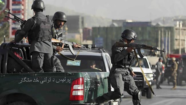 Afghan security personnel arrive after a deadly suicide attack outside a cricket stadium.