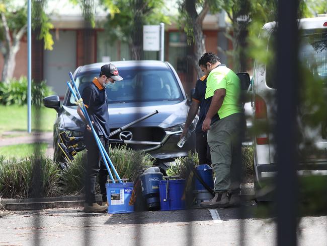 Cleaners at Kincumber High on April 1 after a confirmed COVID-19 case. Picture: AAP/Sue Graham