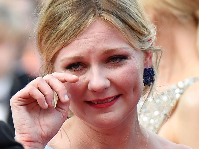 The actress wipes her eyes following the emotional moment.
