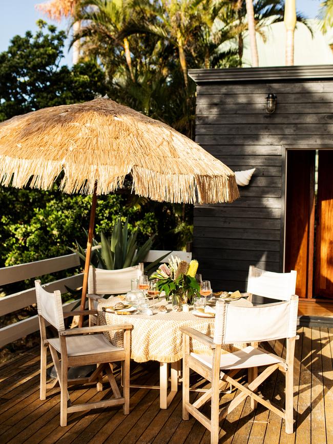 An umbrella shades table and chairs.